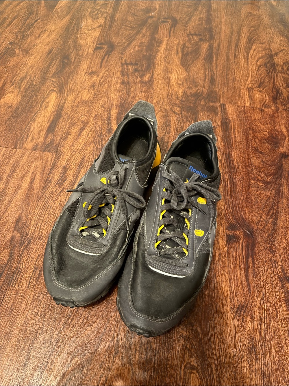 Reebok Men's Black Athletic Shoes with Yellow Accents